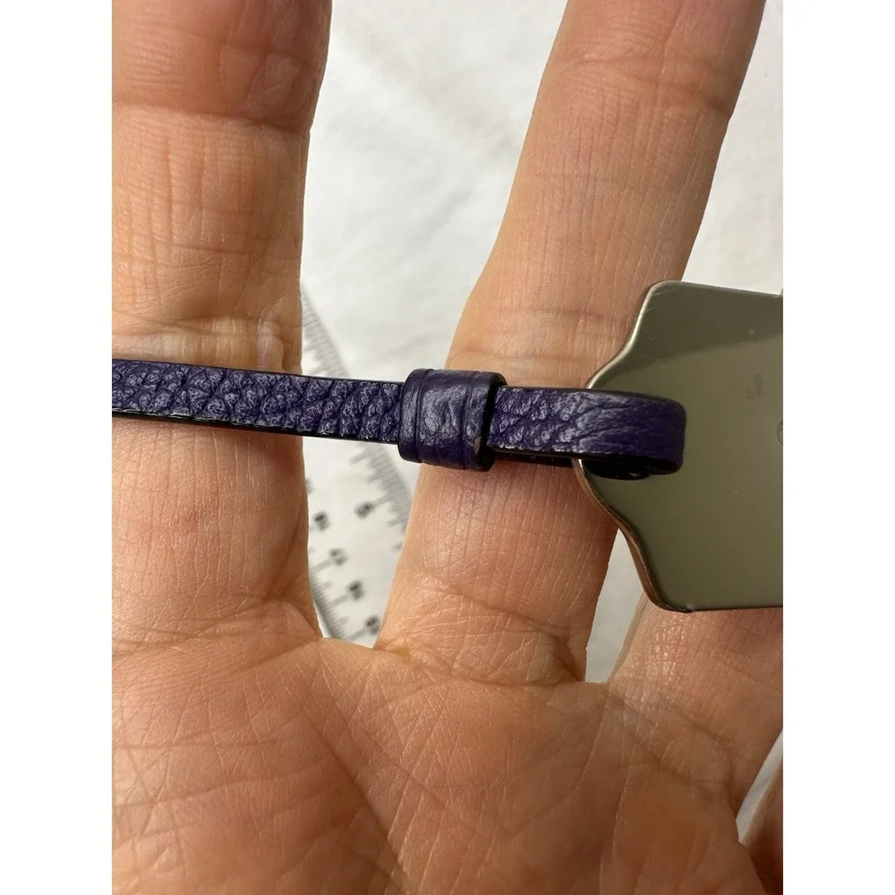 Coach leather strap shown